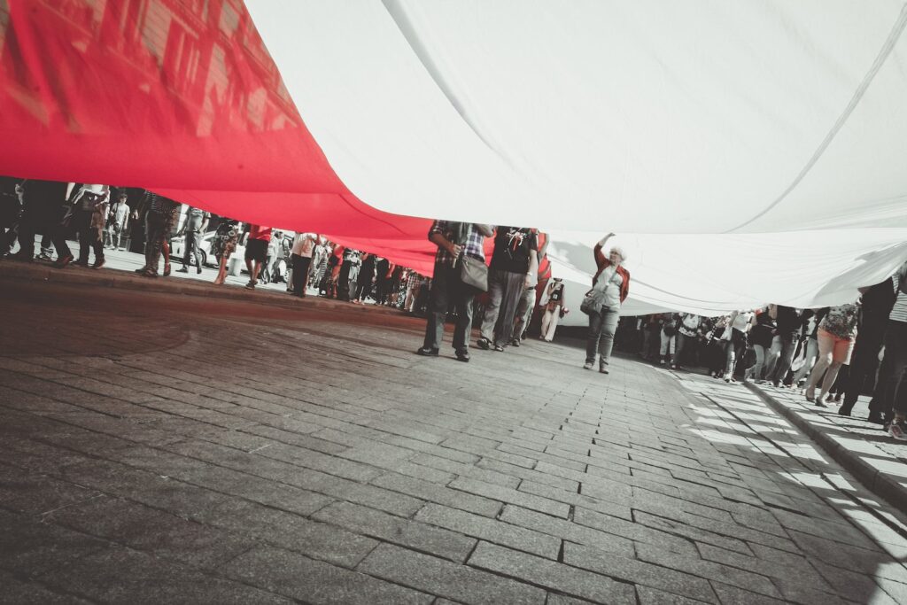 people under white and red textile
