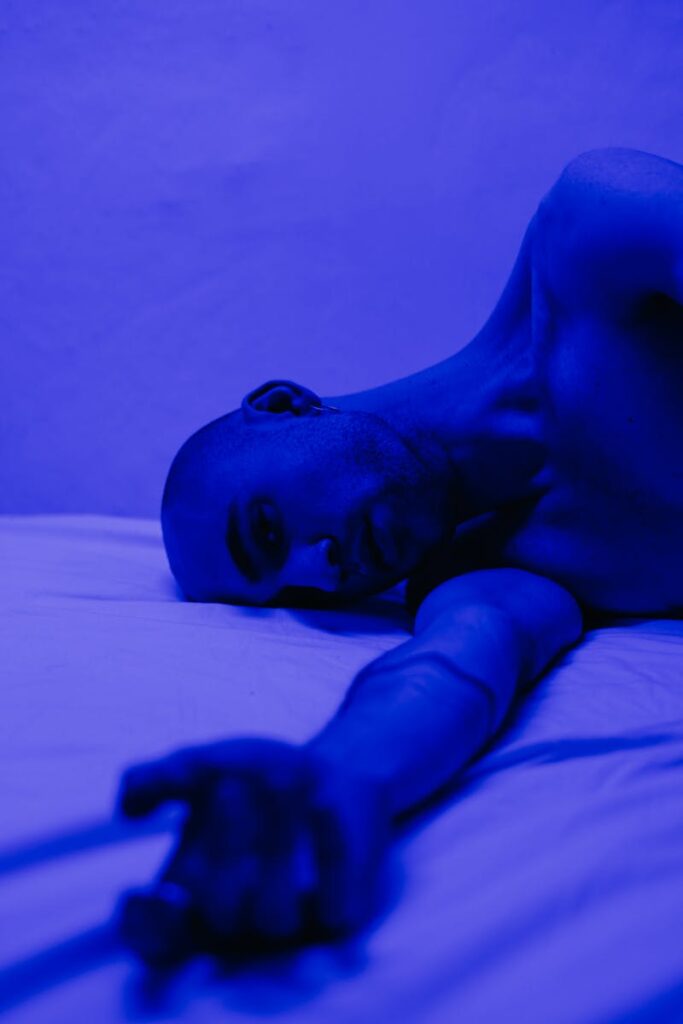 Photo of Man Lying on Bed