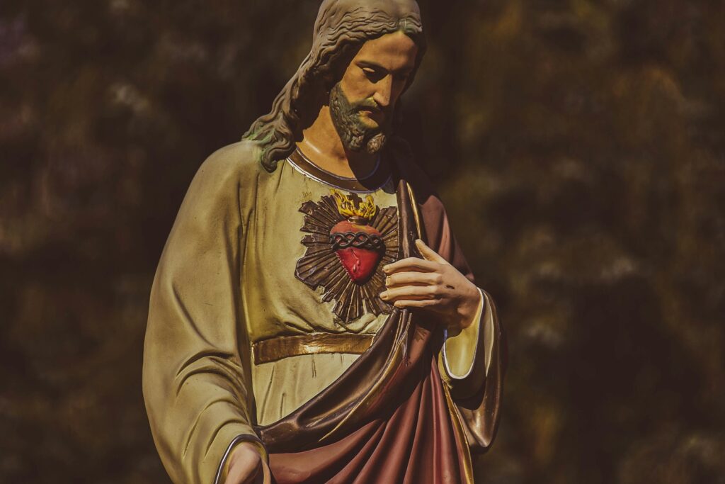 a statue of jesus holding his hands together